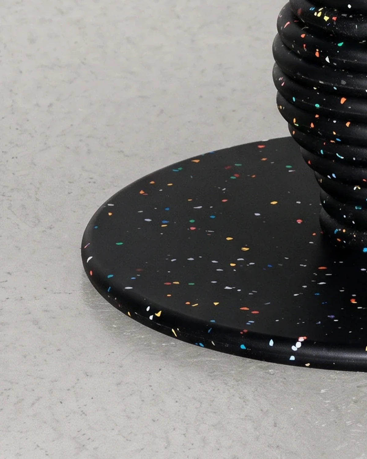 Potter, stacked-disc table Ø80 × 52, black, colour flecks: base close-up