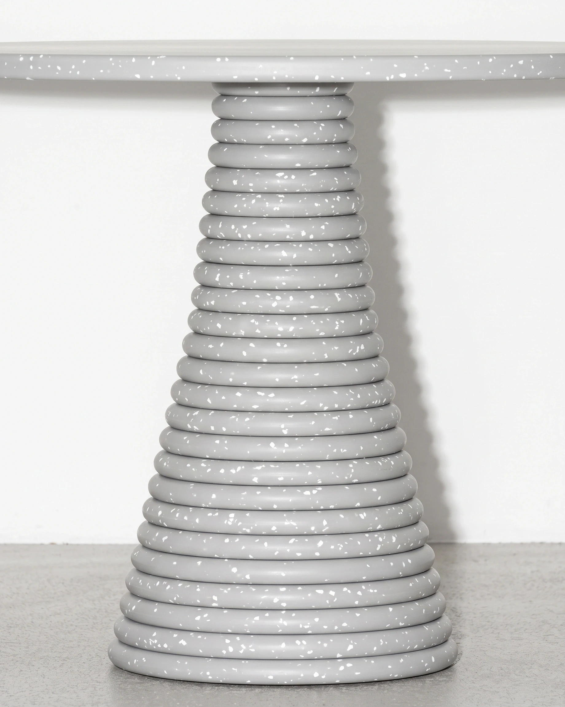Weaver, stacked-disc table Ø80 × 52, cone leg, grey, white flecks: joint close-up