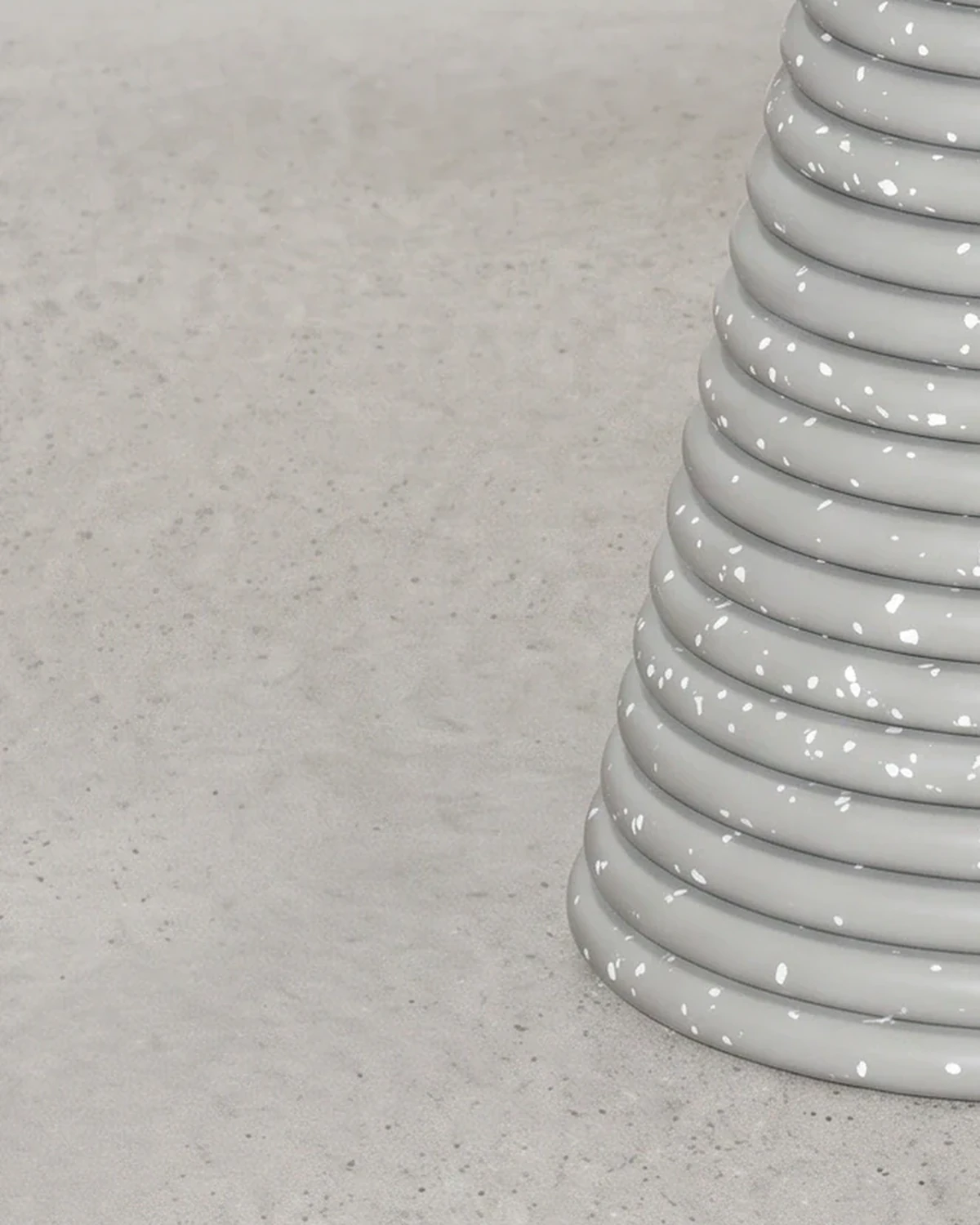 Weaver, stacked-disc table Ø80 × 52, cone leg, grey, white flecks: base close-up