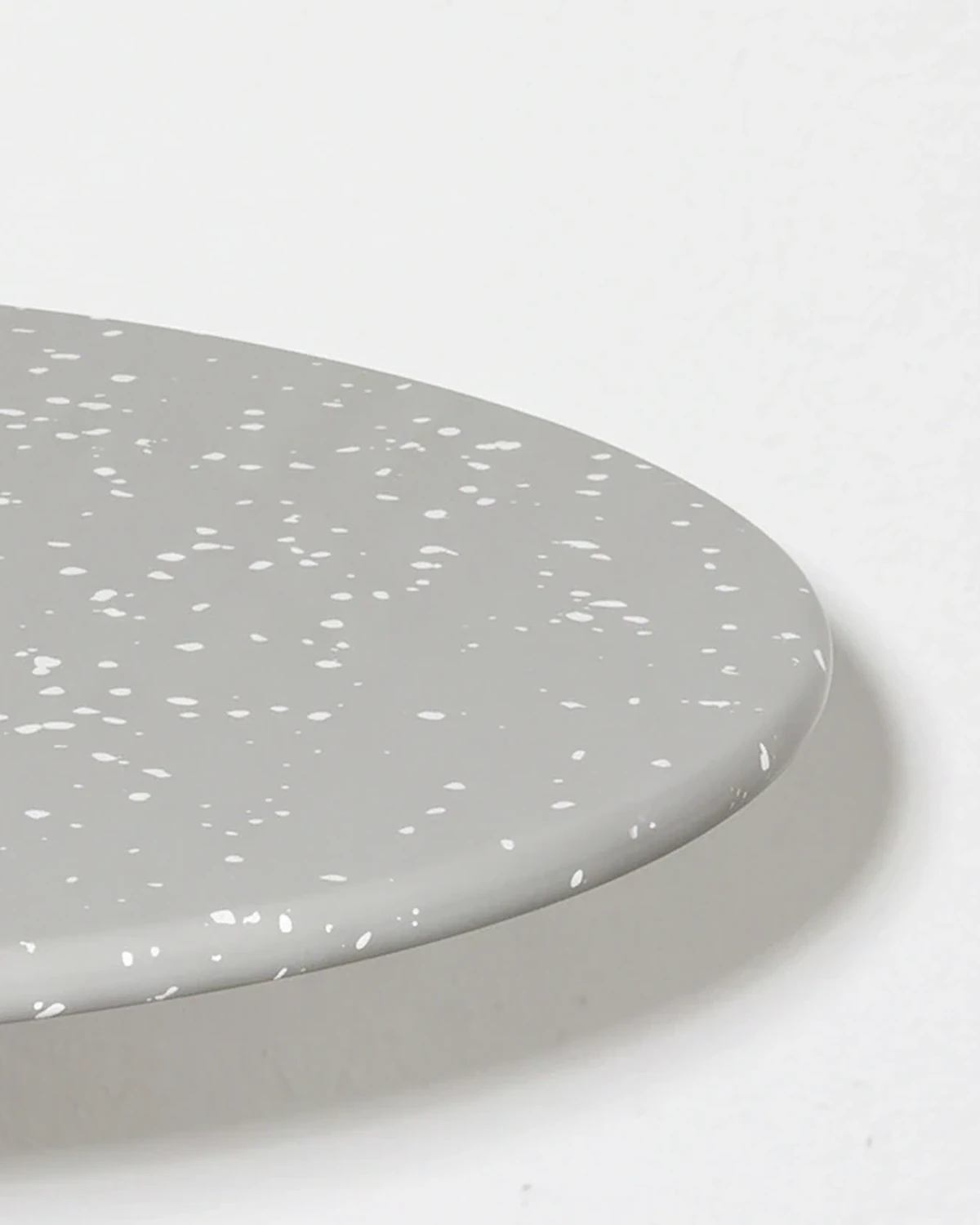 Weaver, stacked-disc table Ø80 × 52, cone leg, grey, white flecks: top corner close-up