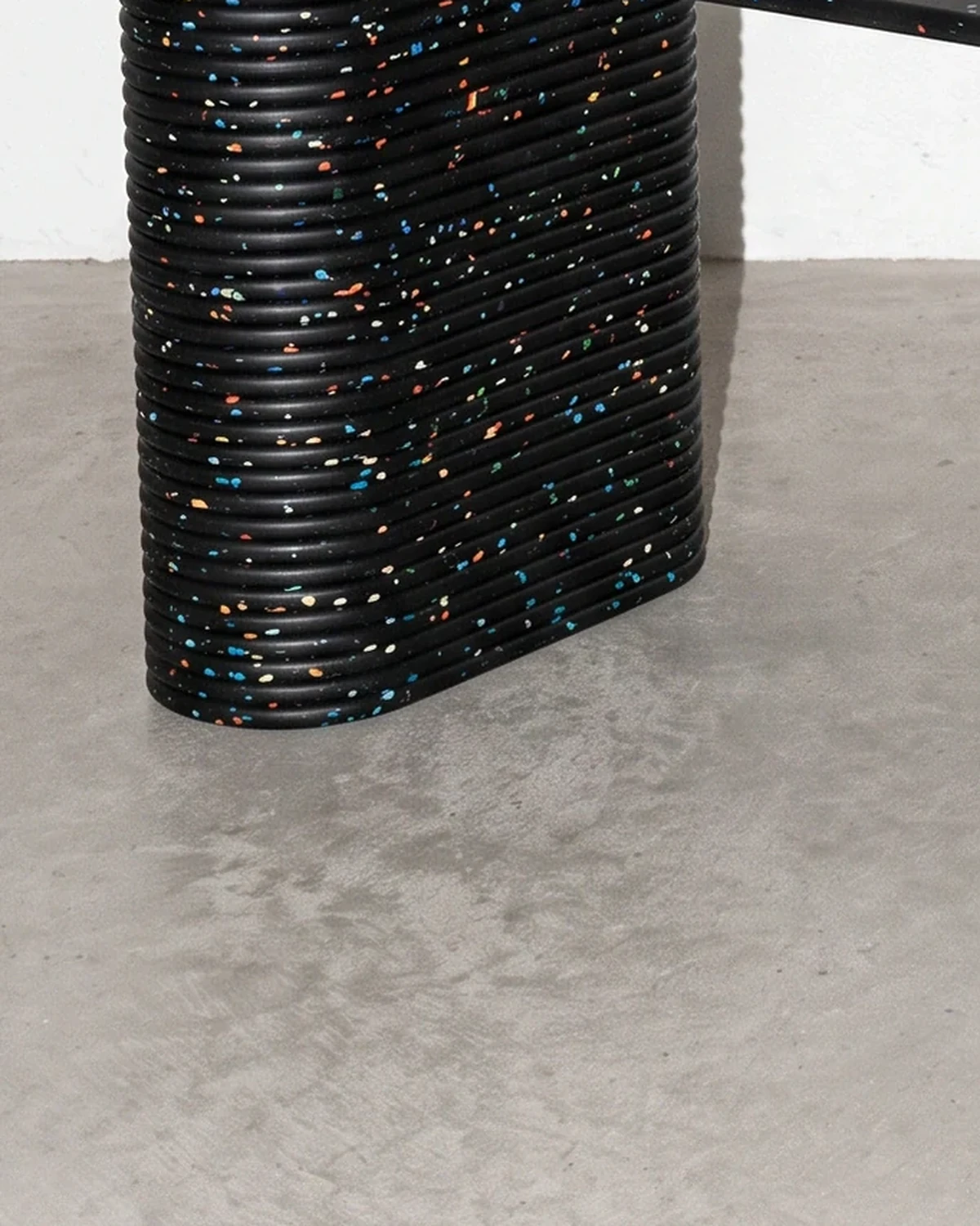 Notary, table on two supports 196 × 90, black, colour flecks: base close-up