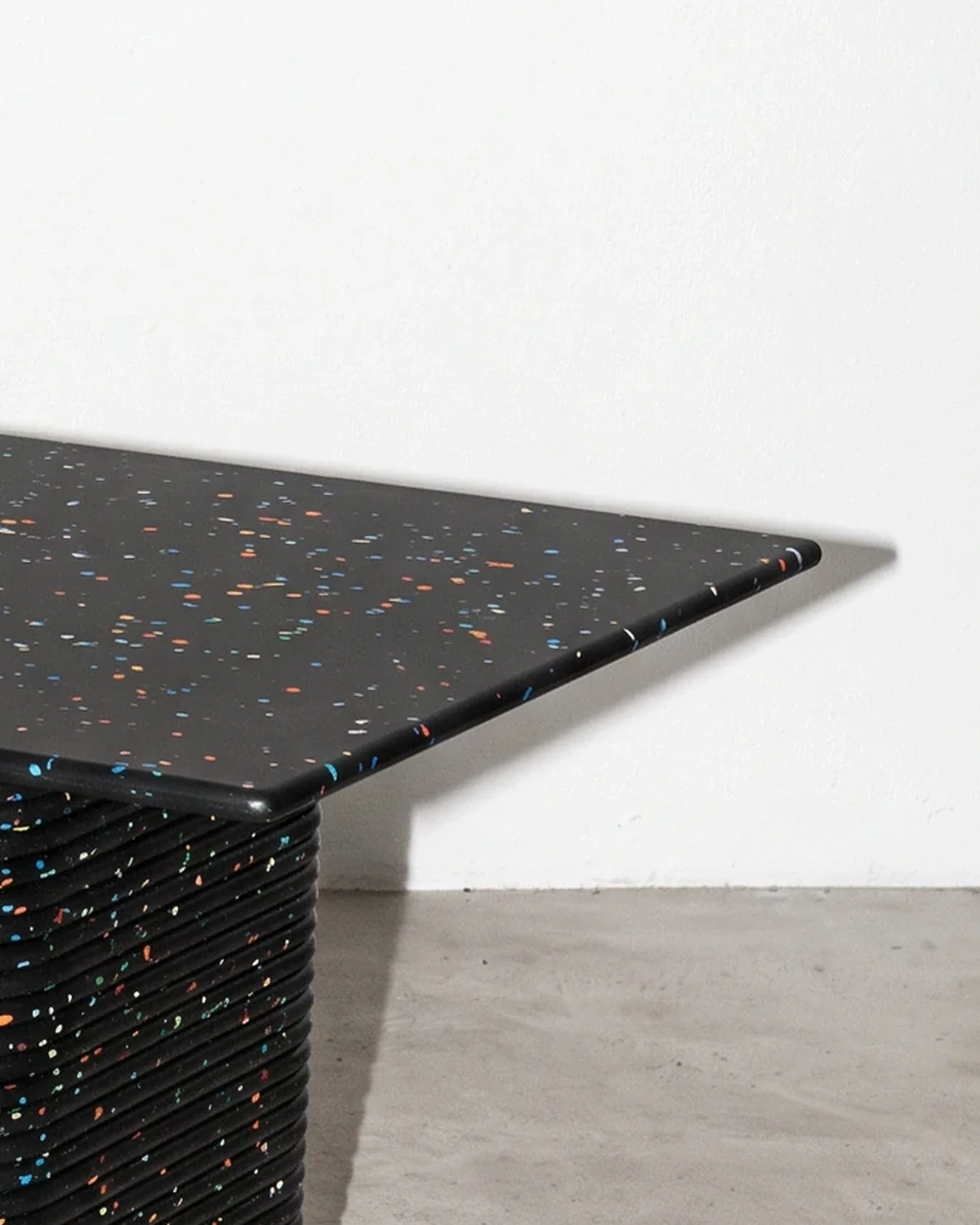 Notary, table on two supports 196 × 90, black, colour flecks: top corner close-up